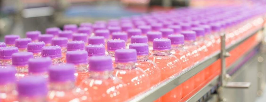Energy shot bottles prepared for hot filling at Nutrition Labs beverage co-packing facility