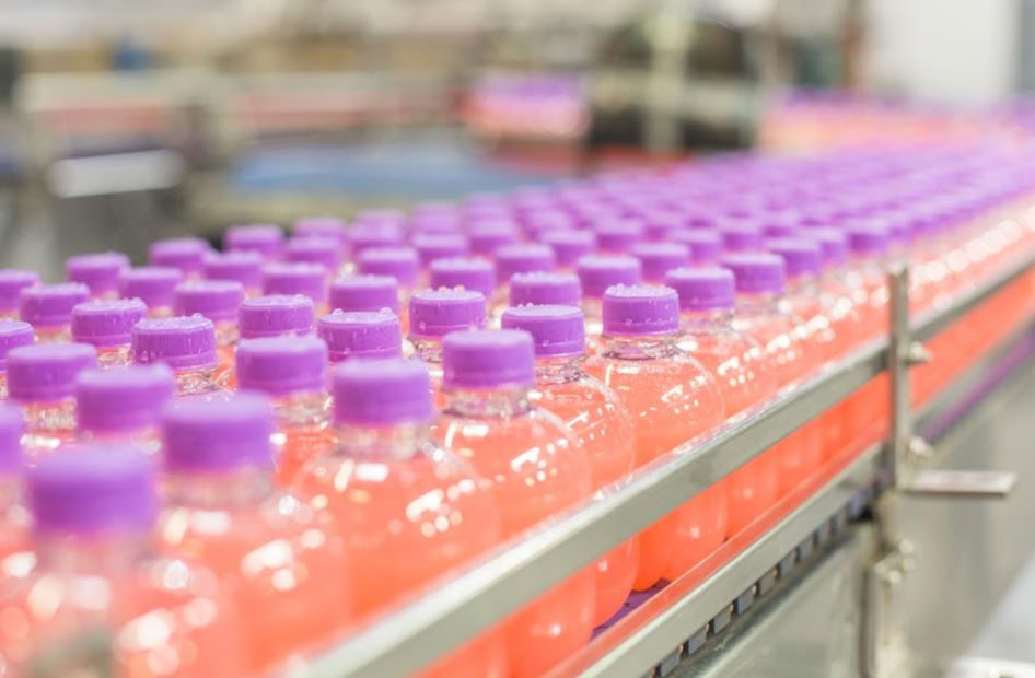 Energy shot bottles prepared for hot filling at Nutrition Labs beverage co-packing facility