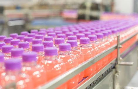 Energy shot bottles prepared for hot filling at Nutrition Labs beverage co-packing facility